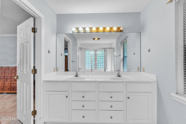 226 Auburn Dr, Alexander City, AL 35010 - bathroom with double vanity, a shower with door, and wood finished floors