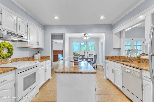 226 Auburn Dr, Alexander City, AL 35010 - kitchen featuring white appliances, under cabinet range hood, a center island, ceiling fan, and white cabinetry