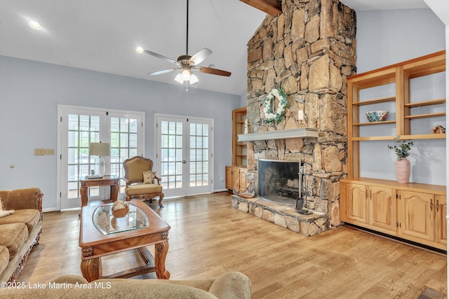 226 Auburn Dr, Alexander City, AL 35010 - living room with a ceiling fan, light wood-style flooring, and a fireplace