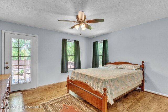 226 Auburn Dr, Alexander City, AL 35010 - bedroom with wood finished floors, multiple windows, a textured ceiling, and ceiling fan