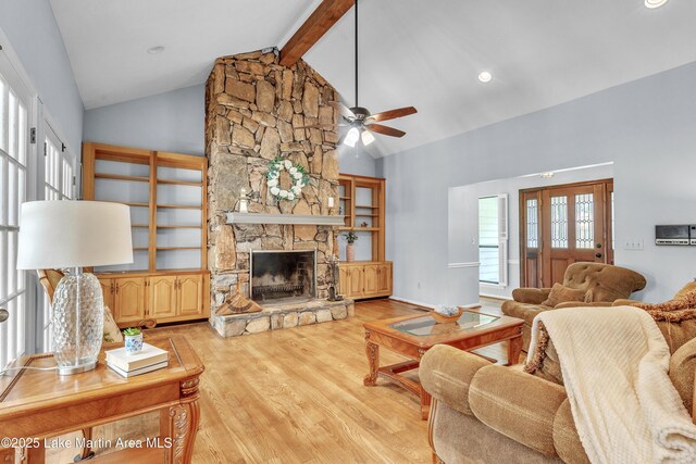 226 Auburn Dr, Alexander City, AL 35010 - living room featuring light wood-type flooring, a ceiling fan, a stone fireplace, high vaulted ceiling, and beam ceiling
