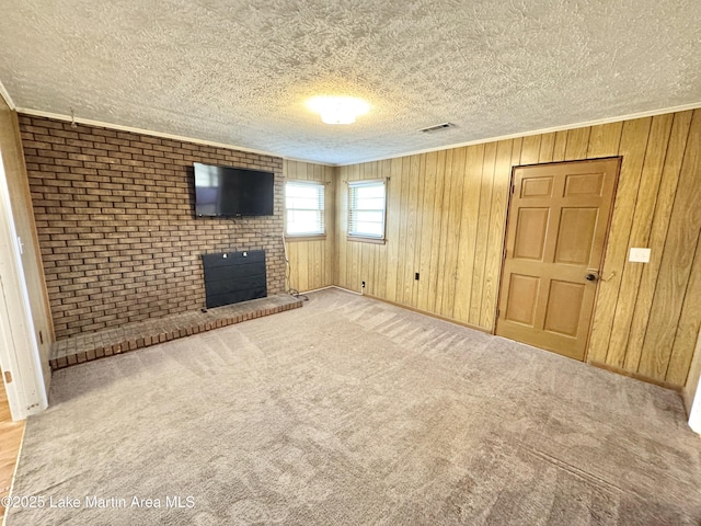 2821 Hillabee Rd, Alexander City, AL 35010 - unfurnished living room featuring a textured ceiling, carpet flooring, a fireplace, and visible vents