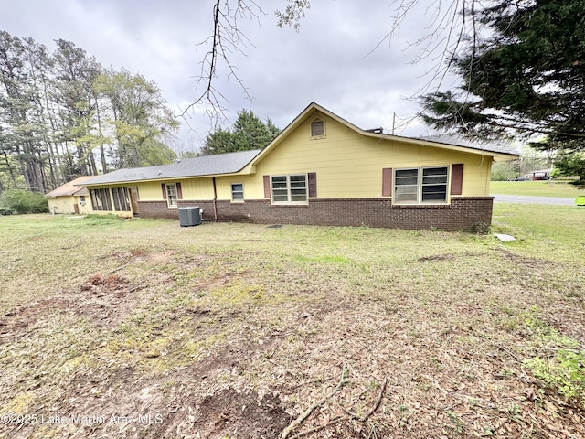 2821 Hillabee Rd, Alexander City, AL 35010 - rear view of property with central air condition unit, a sunroom, brick siding, and a yard