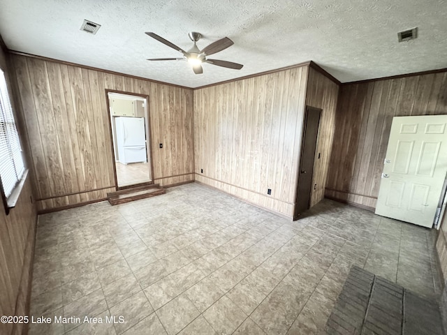 2821 Hillabee Rd, Alexander City, AL 35010 - unfurnished room with visible vents, wood walls, crown molding, and ceiling fan