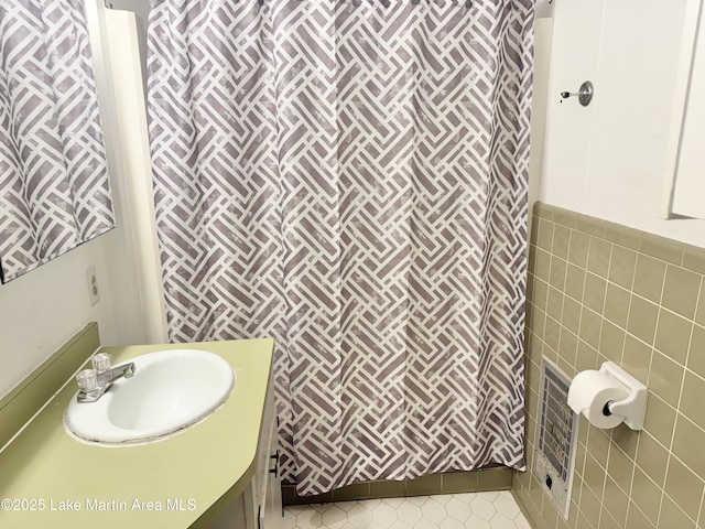 2821 Hillabee Rd, Alexander City, AL 35010 - full bathroom featuring tile patterned floors, vanity, curtained shower, and tile walls