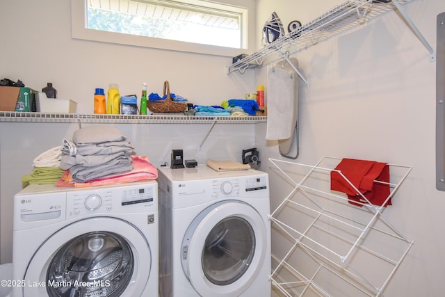 clothes washing area with washer and dryer and laundry area