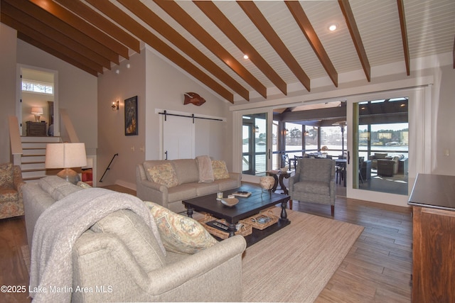 living area featuring beamed ceiling, a barn door, recessed lighting, wood finished floors, and high vaulted ceiling