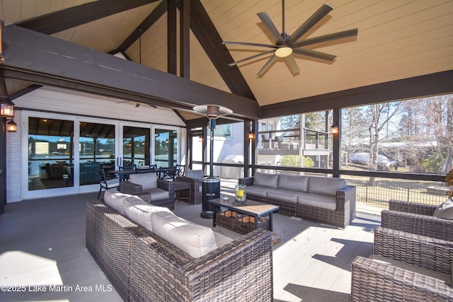 sunroom with lofted ceiling and a ceiling fan