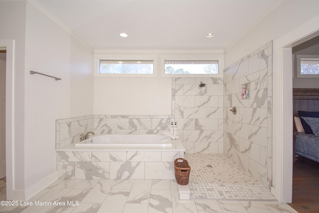 ensuite bathroom with connected bathroom, plenty of natural light, a bath, and a tile shower