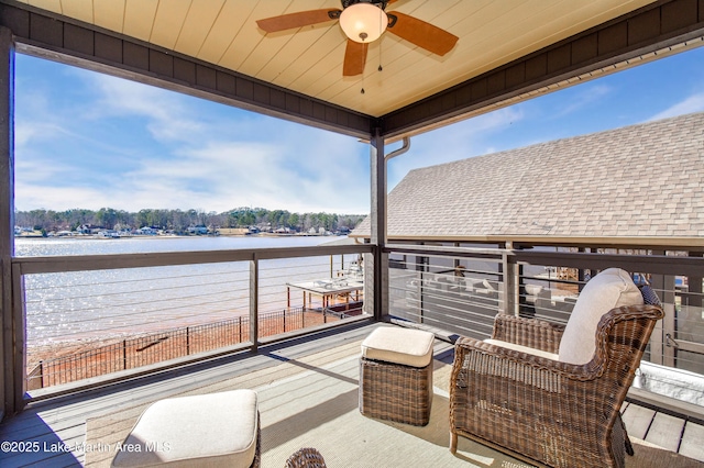 exterior space with a water view and ceiling fan