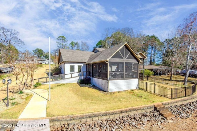 exterior space with fence, a yard, and a sunroom