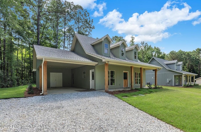 27 Bob Lo Dr, Dadeville, AL 36853 - view of front of home with driveway, a carport, a front yard, roof with shingles, and covered porch