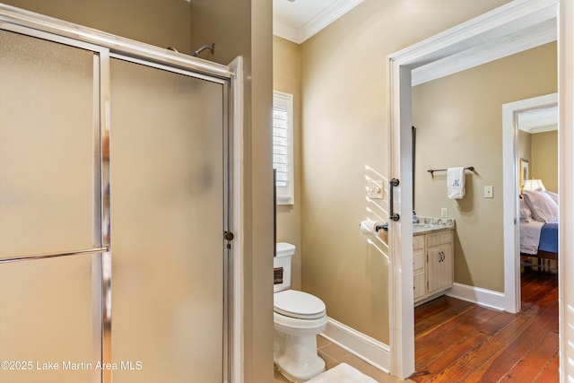 bathroom featuring an enclosed shower, wood-type flooring, vanity, toilet, and ornamental molding