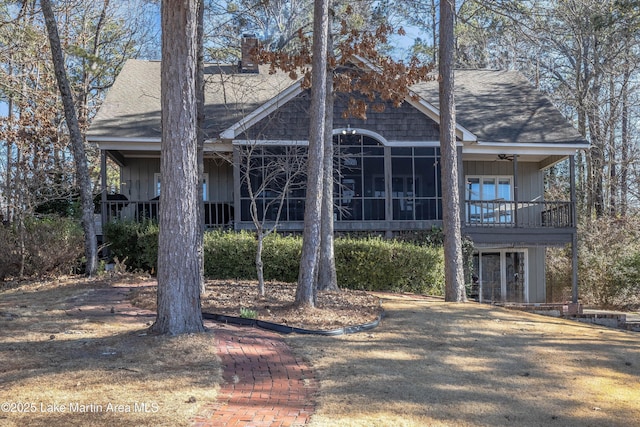 back of house with ceiling fan and a sunroom