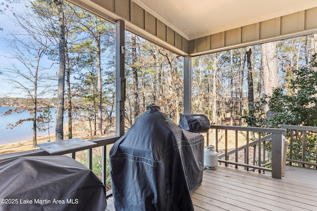 wooden terrace featuring a water view and grilling area