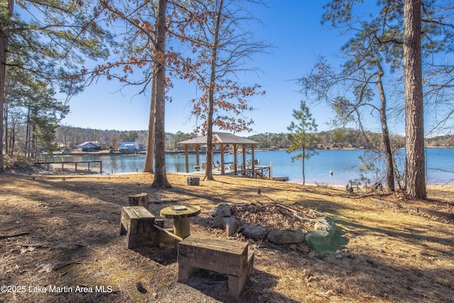 view of yard featuring a gazebo and a water view