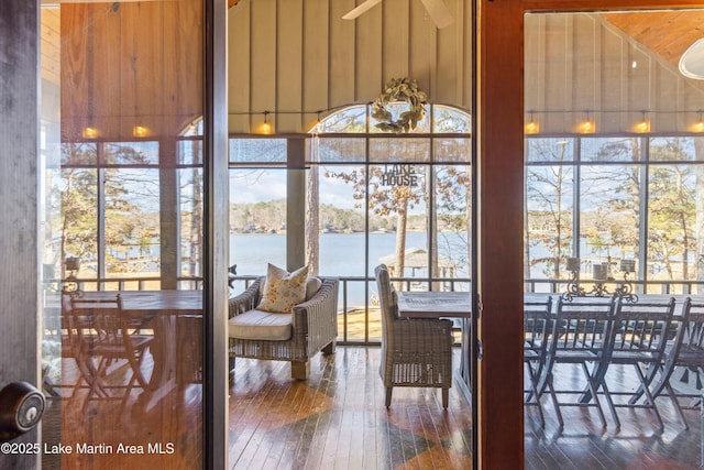 sunroom / solarium featuring a water view