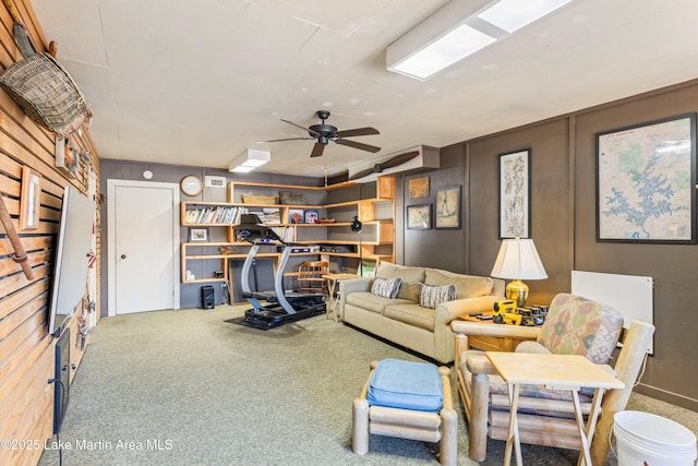 living room featuring ceiling fan and carpet