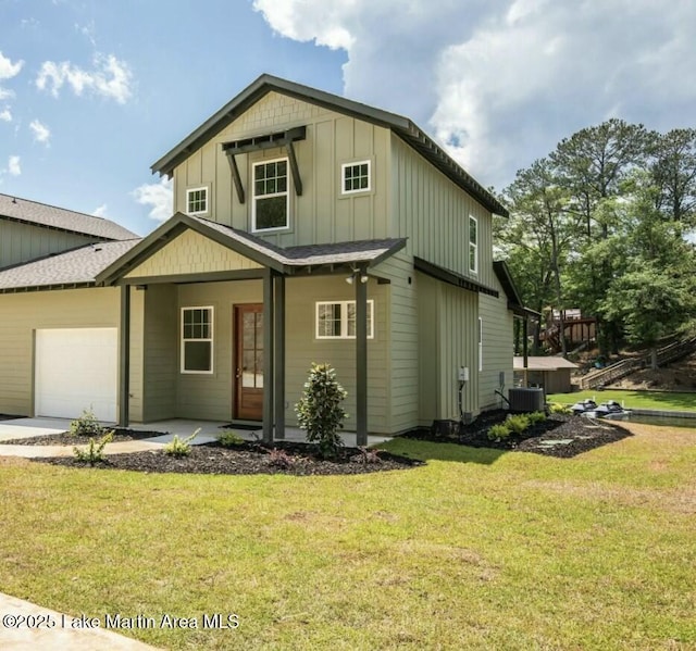 view of front facade with board and batten siding, a front lawn, a garage, and central AC unit