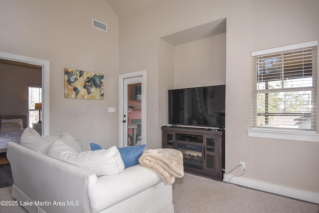 carpeted living room with lofted ceiling