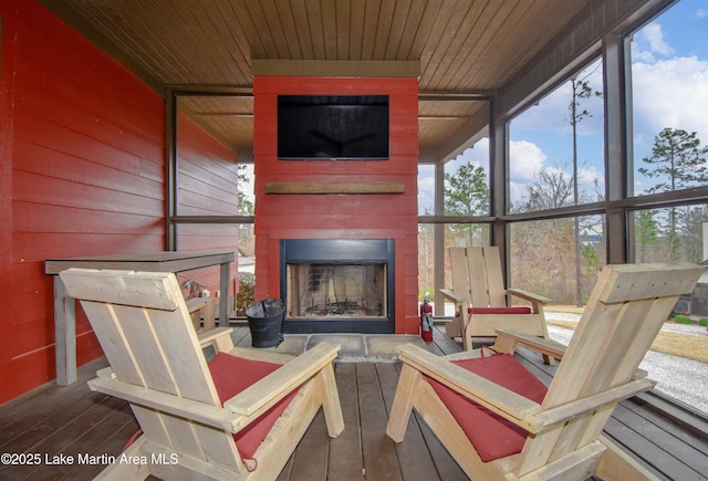 sunroom / solarium with wooden ceiling and a fireplace