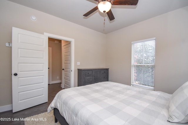 bedroom featuring ceiling fan and dark wood-type flooring