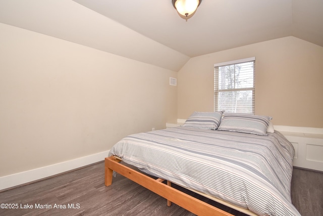 bedroom featuring dark hardwood / wood-style floors and lofted ceiling