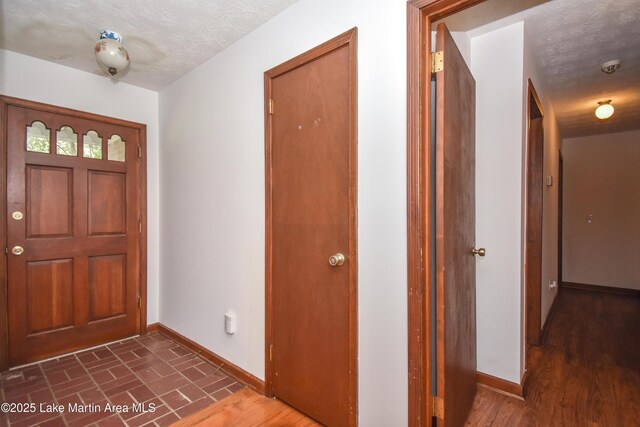 300 Hornsby Dr, Tallassee, AL 36078 - entryway with baseboards and a textured ceiling