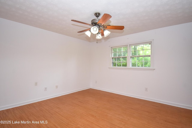300 Hornsby Dr, Tallassee, AL 36078 - unfurnished room with light wood-style floors, a ceiling fan, baseboards, and a textured ceiling