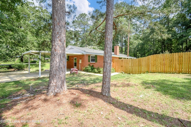 300 Hornsby Dr, Tallassee, AL 36078 - view of yard featuring a carport