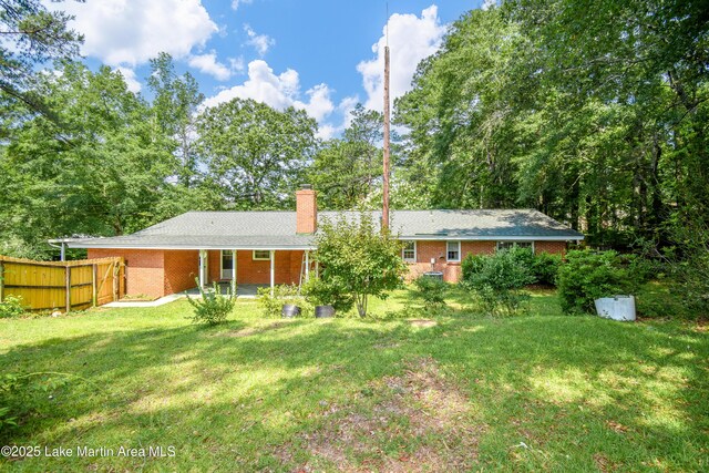300 Hornsby Dr, Tallassee, AL 36078 - back of property with a chimney, brick siding, and a patio
