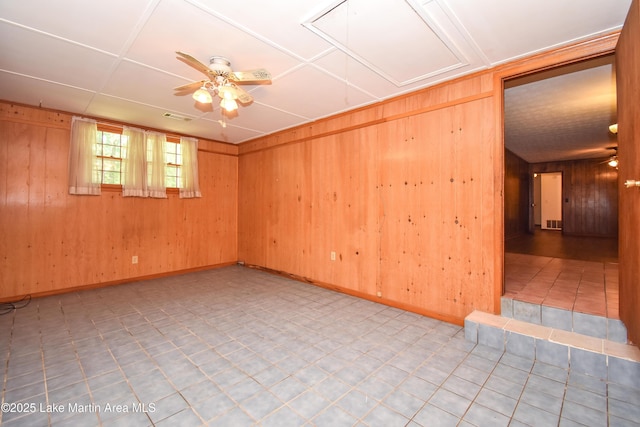 300 Hornsby Dr, Tallassee, AL 36078 - spare room featuring wooden walls, a ceiling fan, and baseboards