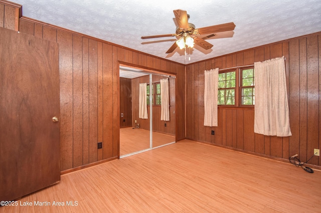 300 Hornsby Dr, Tallassee, AL 36078 - spare room with wood finished floors, a ceiling fan, baseboards, and wood walls