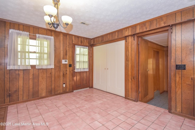 300 Hornsby Dr, Tallassee, AL 36078 - entryway featuring wooden walls, a chandelier, and baseboards