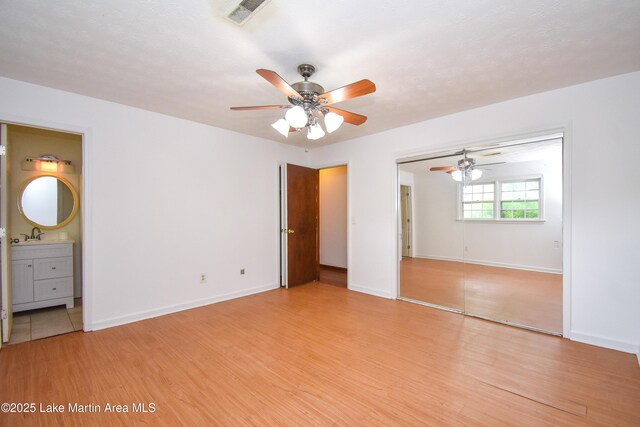 300 Hornsby Dr, Tallassee, AL 36078 - unfurnished bedroom featuring light wood-type flooring, baseboards, and a closet