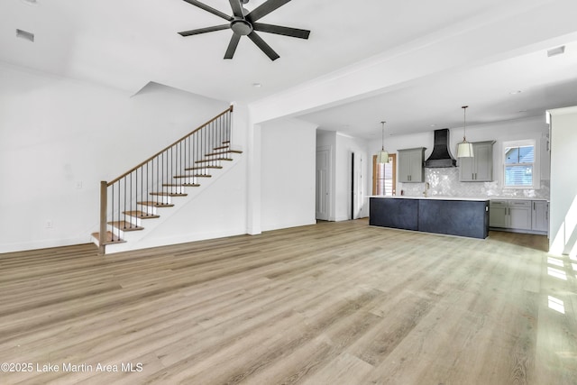194 Oliver Way, Dadeville, AL 36853 - unfurnished living room featuring light wood-style floors, stairway, and ceiling fan
