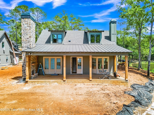 194 Oliver Way, Dadeville, AL 36853 - back of property with a standing seam roof, a chimney, roof with shingles, and a metal roof
