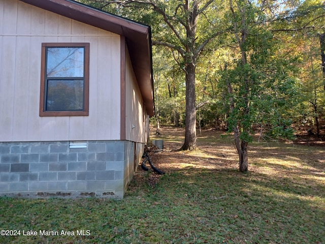 view of side of home featuring a lawn and central AC unit