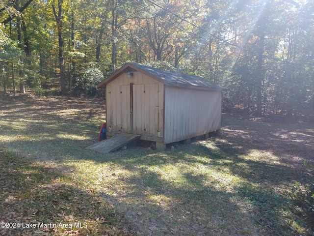 view of outdoor structure with a lawn