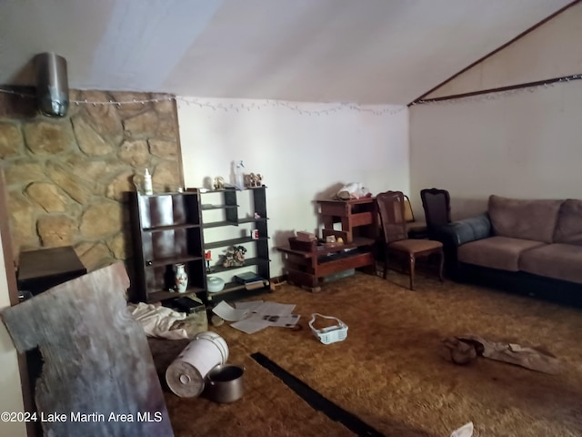 living room featuring carpet floors and vaulted ceiling