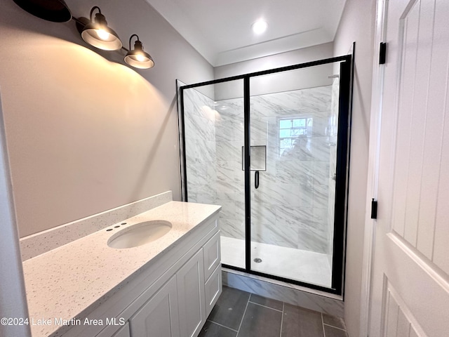 bathroom featuring vanity, tile patterned floors, and a shower with shower door