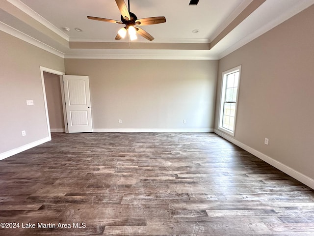 spare room with hardwood / wood-style floors, a raised ceiling, ceiling fan, and crown molding