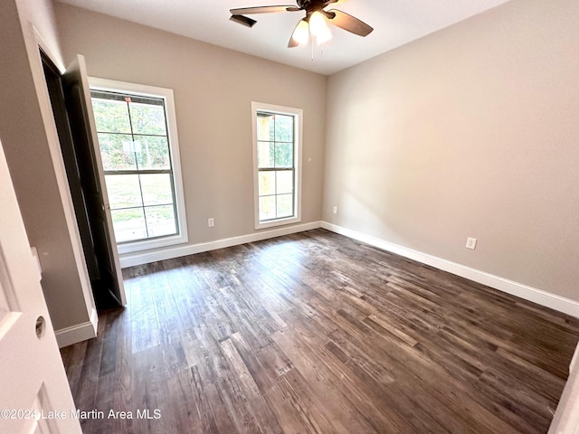 empty room featuring ceiling fan and dark wood-type flooring