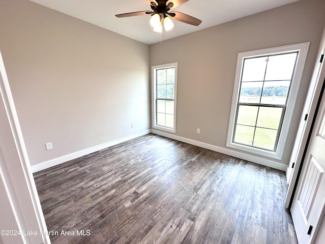 unfurnished room featuring ceiling fan and dark wood-type flooring