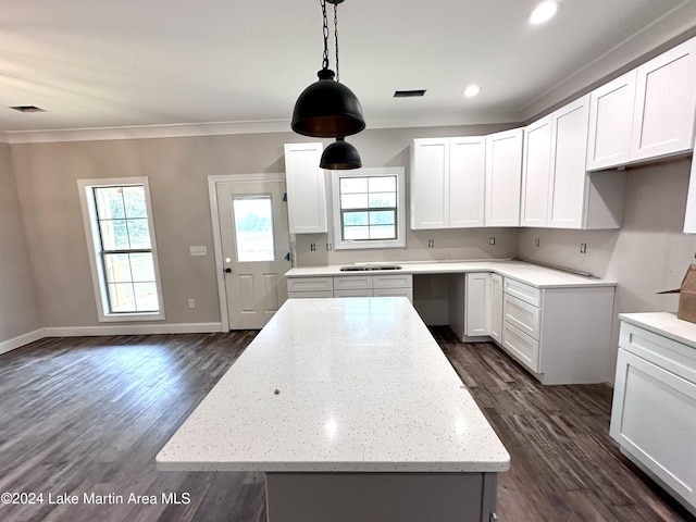 kitchen with white cabinetry, a wealth of natural light, a kitchen island, and dark hardwood / wood-style floors