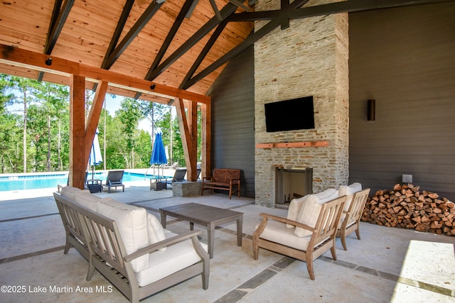 view of patio with an outdoor living space with a fireplace