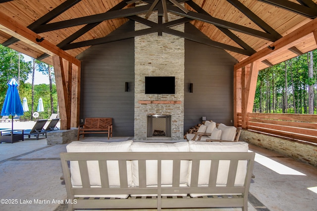 view of patio / terrace with an outdoor living space with a fireplace