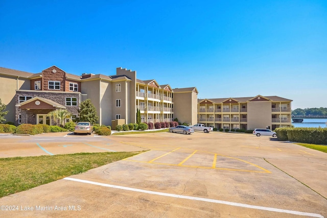 view of building exterior featuring uncovered parking