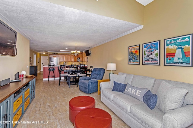 living area featuring a textured ceiling, crown molding, and a notable chandelier
