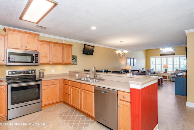 kitchen with a peninsula, light countertops, a sink, and appliances with stainless steel finishes